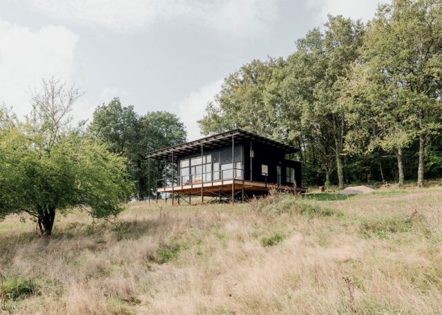 stand alone house on stilts in greenery