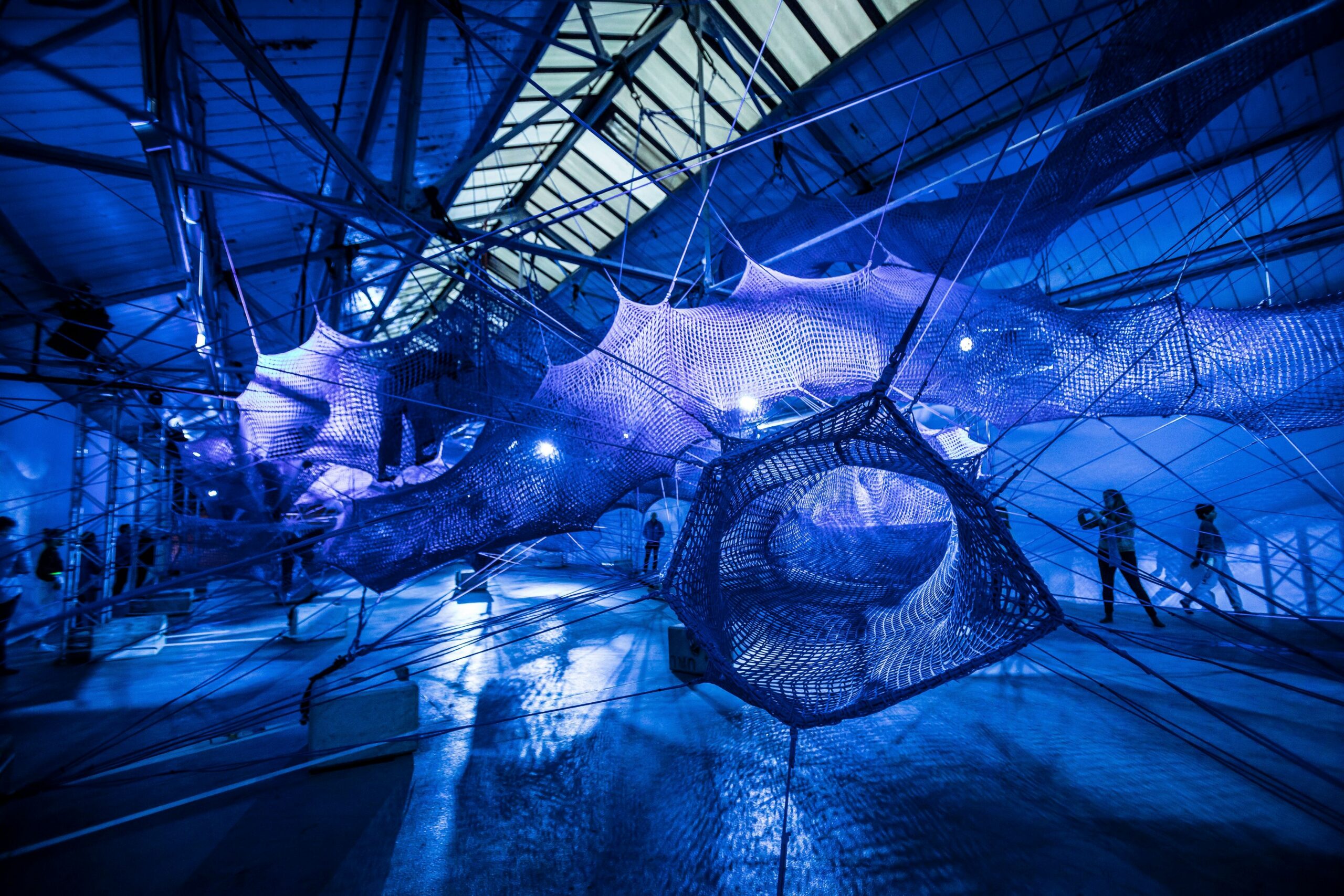 blue lit-room full of giant nets